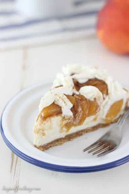 A brown sugar cheesecake in a vanilla wafer crust topped with brown sugar peaches and cinnamon.