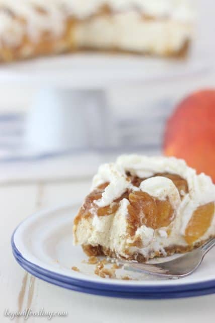 A brown sugar cheesecake in a vanilla wafer crust topped with brown sugar peaches and cinnamon.