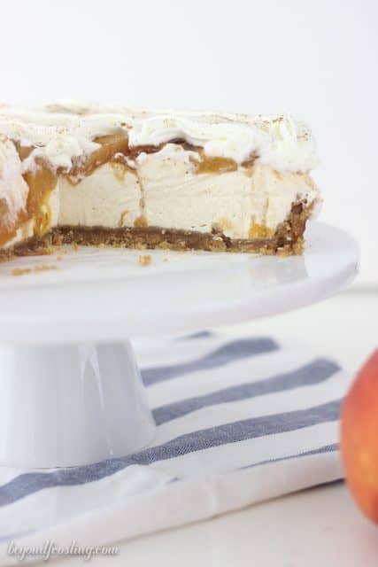 A brown sugar cheesecake in a vanilla wafer crust topped with brown sugar peaches and cinnamon.