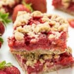 An oatmeal cookie base topped with strawberries and rhubarb and topped with more oatmeal cookie topping -- your favorite summer dessert is now a packable treat or back to school snack!