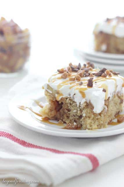 This Caramel Apple Poke Cake is a brown sugar cake with a cinnamon streusel swirl. It is soaked in caramel and topped with apple pie filling and whipped cream.