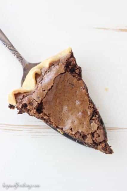 This Espresso Brownie Pie is flaky on the outside and fudgy in the middle. It is loaded with chocolate covered espresso beans