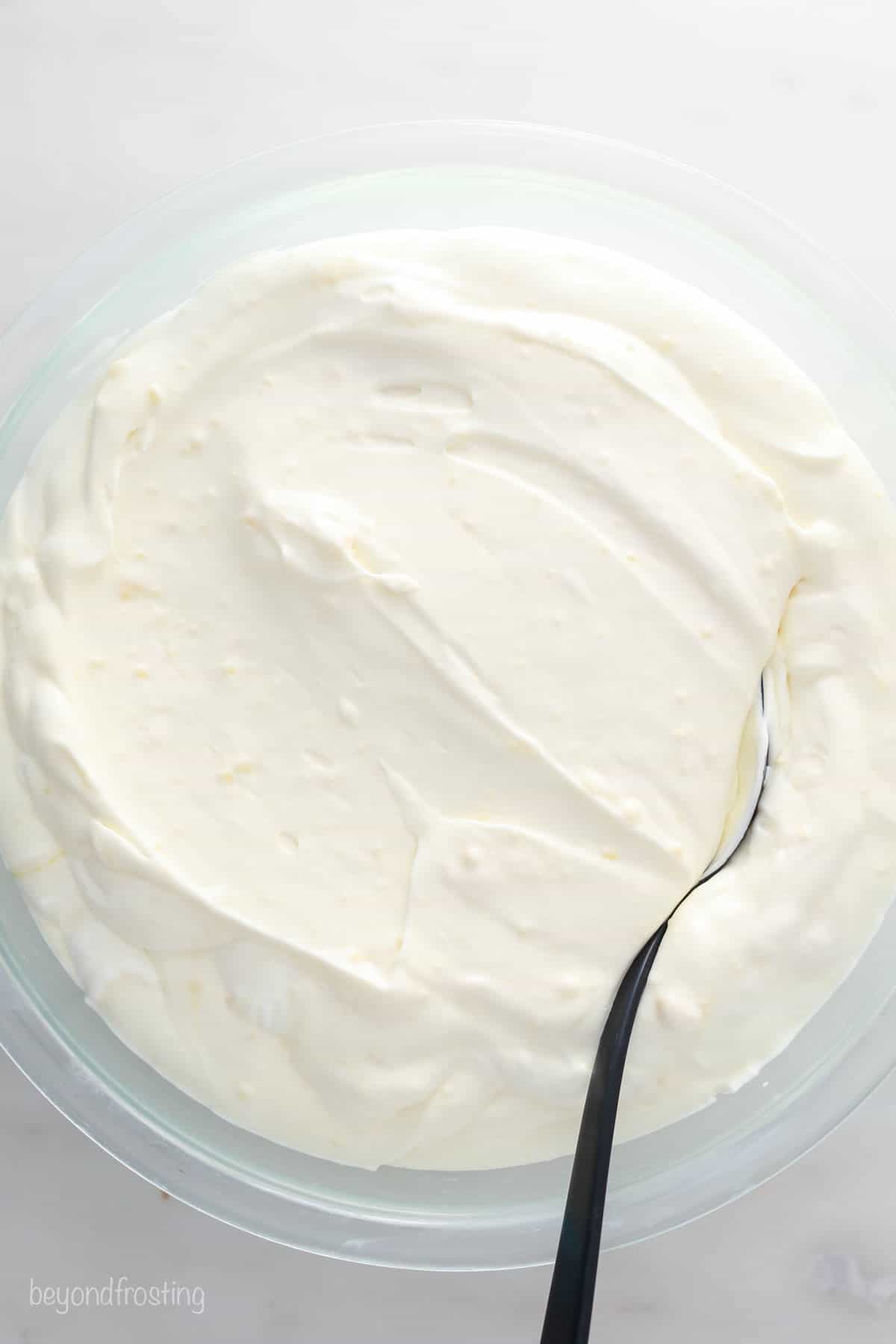 This copycat Magnolia Bakery banana pudding recipe has sliced bananas and softened Nilla Wafers layered with light, fluffy vanilla pudding. A glass bowl filled with mousse