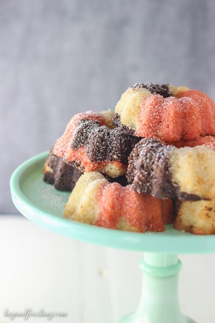 These Mini Neapolitan Bundt Cakes are a blend of vanilla, chocolate and strawberry cake baked together to create the most delicious mini cakes. 