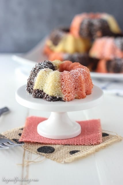 These Mini Neapolitan Bundt Cakes are a blend of vanilla, chocolate and strawberry cake baked together to create the most delicious mini cakes. Finish them off with a dusting of powder sugar. 