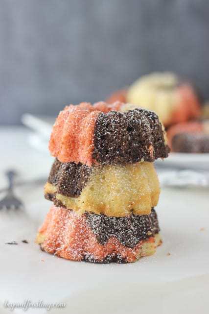 These Mini Neapolitan Bundt Cakes are a blend of vanilla, chocolate and strawberry cake baked together to create the most delicious mini cakes. Finish them off with a dusting of powder sugar. 