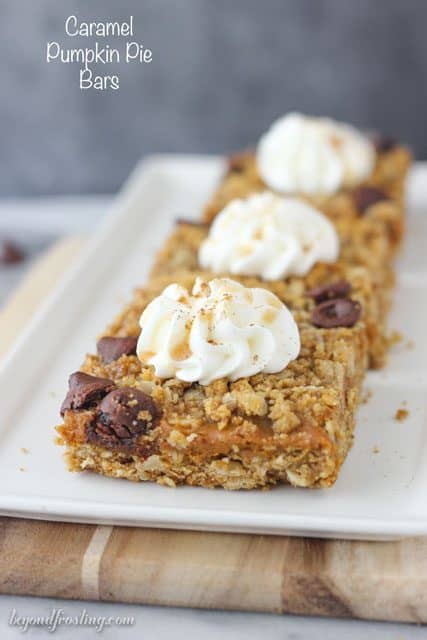 These gooey Caramel Pumpkin Pie Bars layered with a brown sugar oatmeal crust, pumpkin caramel filling and caramel filled chocolate chips.