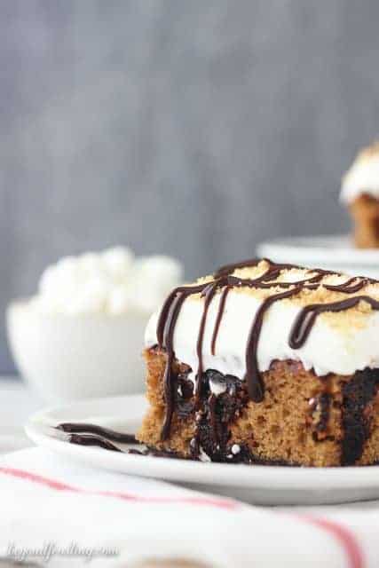 This Pumpkin S’more Poke Cake is a pumpkin cake with a chocolate graham cracker crust. It is soaked with chocolate pudding and topped with a marshmallow whipped cream. 