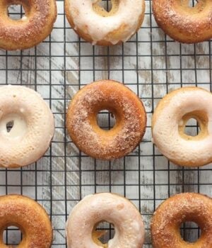 An overhead shot of cider donuts on a wire cooling rack