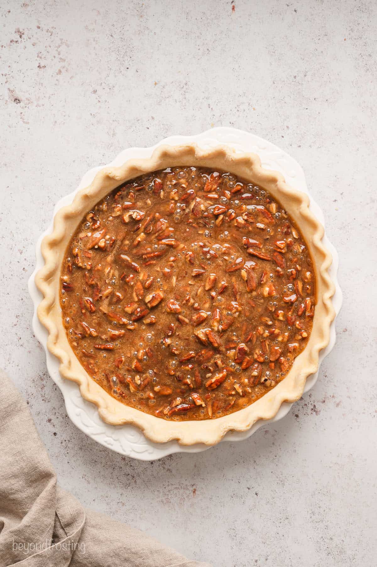 Unbaked pecan pie in a pie plate.