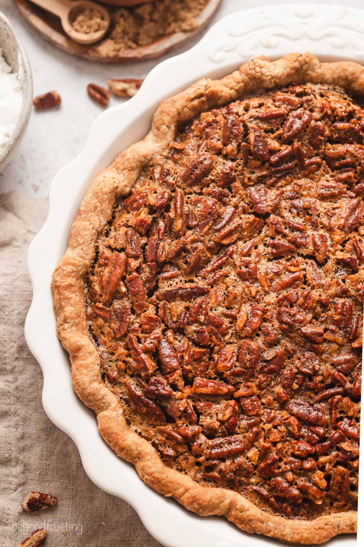 Close up overhead view of a whole pecan pie in a ceramic pie plate.