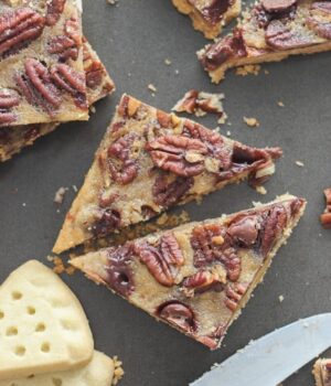 These Bourbon Pecan Pie Bars feature a buttery shortbread crust with a bourbon spike filling loaded with pecans and chocolate chips.