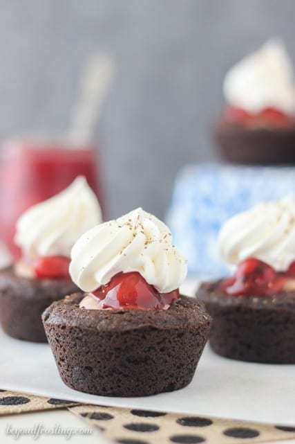 These Black Forest Cookie Cups are a soft baked chocolate cookie filled with chocolate mousse and cherry pie filling. All topped with fresh whipped cream and chocolate shavings.