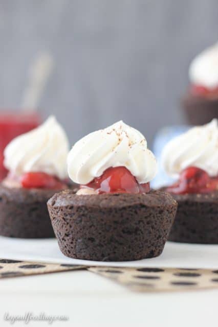 These Black Forest Cookie Cups are a soft baked chocolate cookie filled with chocolate mousse and cherry pie filling. All topped with fresh whipped cream and chocolate shavings.