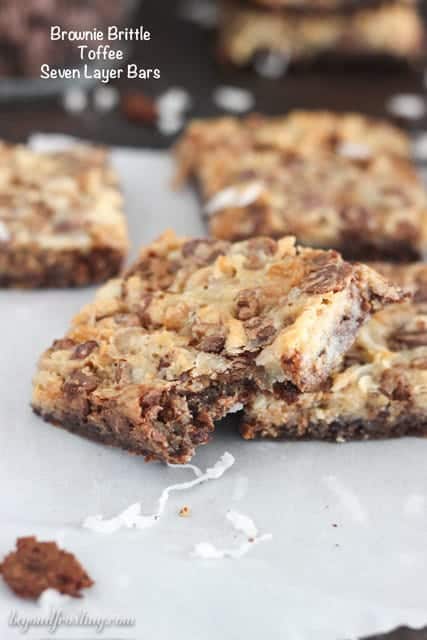 These Brownie Brittle Toffee Seven Layer Bars will wow your friends! A Brownie Brittle Toffee crust layered with coconut, walnuts, caramel chips and toffee.