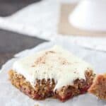 Gooey Gingerbread Cake Bars with cherry pie filling and vanilla frosting.