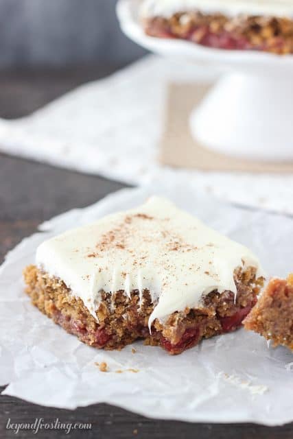 Gooey Gingerbread Cake Bars with cherry pie filling and vanilla frosting.