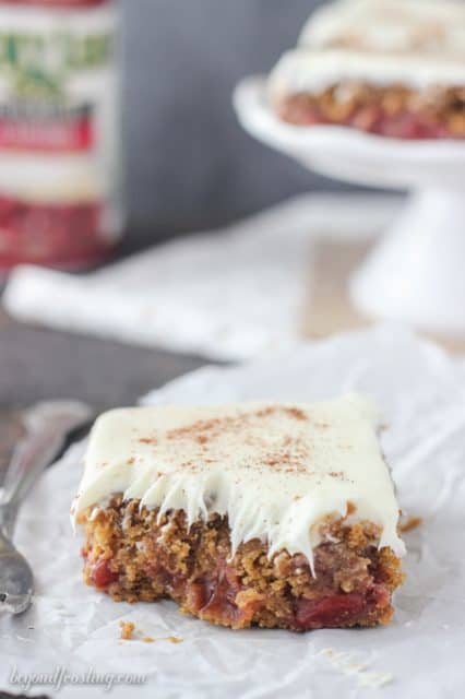 Gooey Gingerbread Cake Bars with cherry pie filling and vanilla frosting.