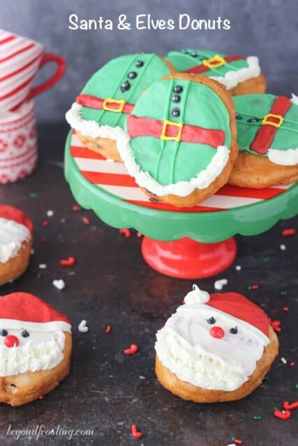 These Santa and Elves Donuts are made with Pillsbury Grands Biscuits, filled with a chocolate buttercream and decorated santa heads and elves.