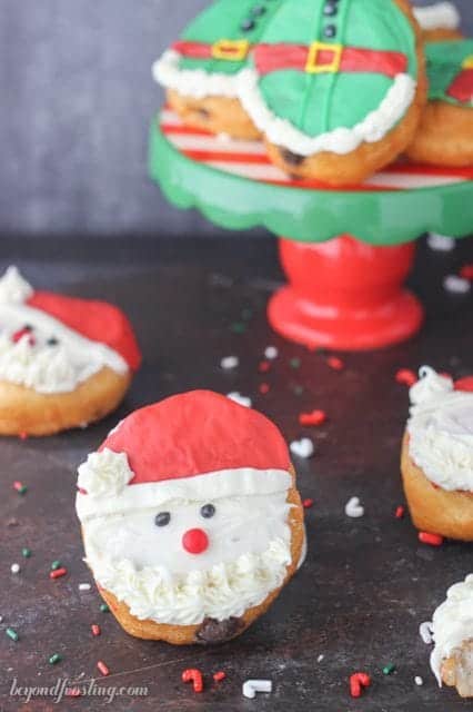 These Santa and Elves Donuts are made with Pillsbury Grands Biscuits, filled with a chocolate buttercream and decorated santa heads and elves.