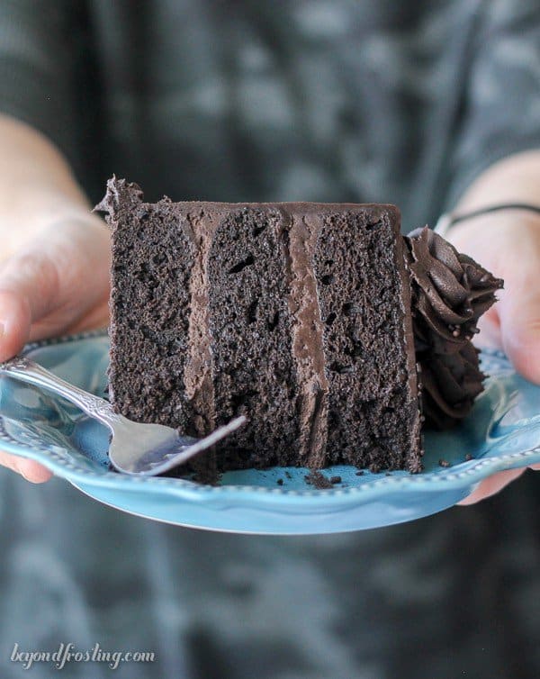 A slice of Guinness Chocolate Cake being held on a plate