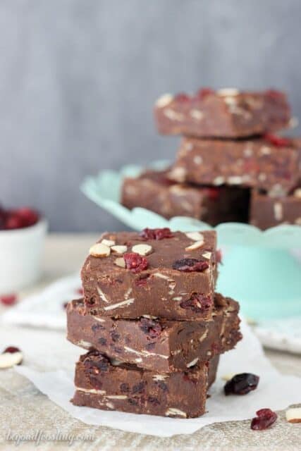 Stacked Cranberry Almond Fudge pieces with sliced almonds and cranberries.