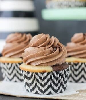 A close up shot of a Baileys marbled vanilla and chocolate cupcake with chocolate frosting