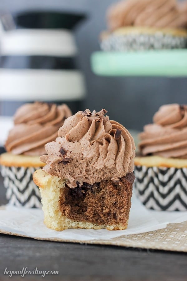 A marbled cupcake with a bite missing showing the inside of the cupcake