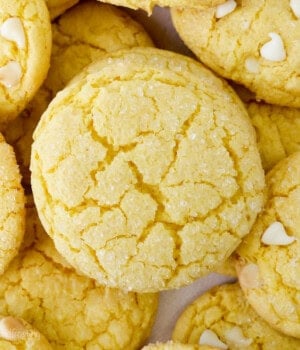 Overhead close up view of assorted lemon cake mix cookies, some filled with white chocolate chips.