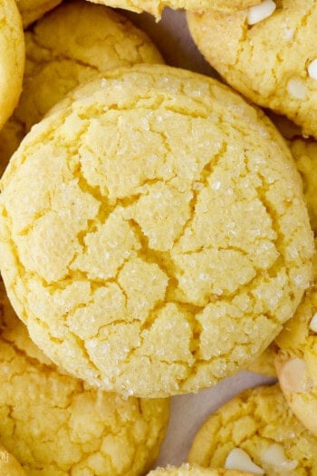 Overhead close up view of assorted lemon cake mix cookies, some filled with white chocolate chips.