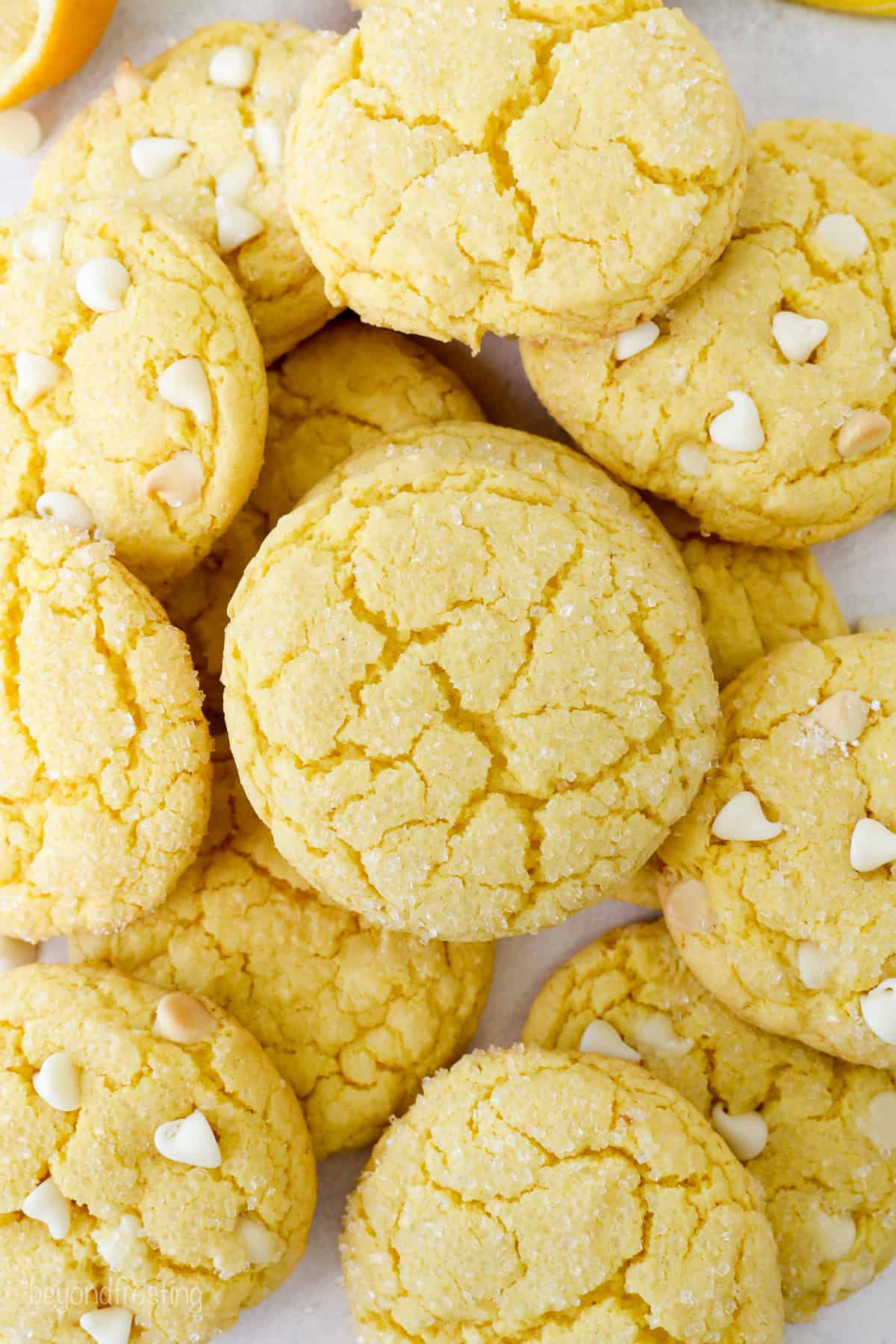 Overhead view of assorted lemon cake mix cookies, some filled with white chocolate chips.