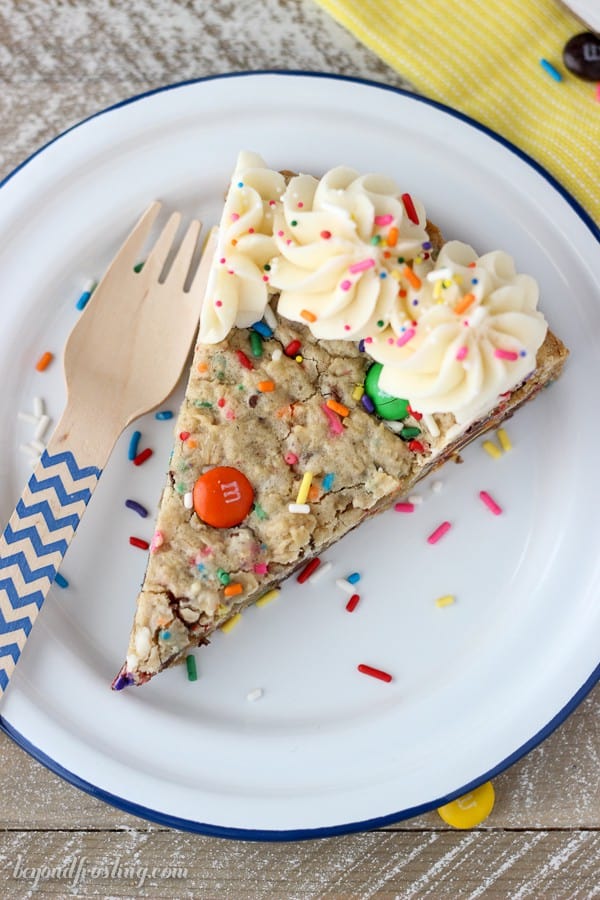 This Cake Batter Monster Cookie Cake is an cake batter oatmeal cookie with MnMs and sprinkles. It’s topped with a little vanilla buttercream.