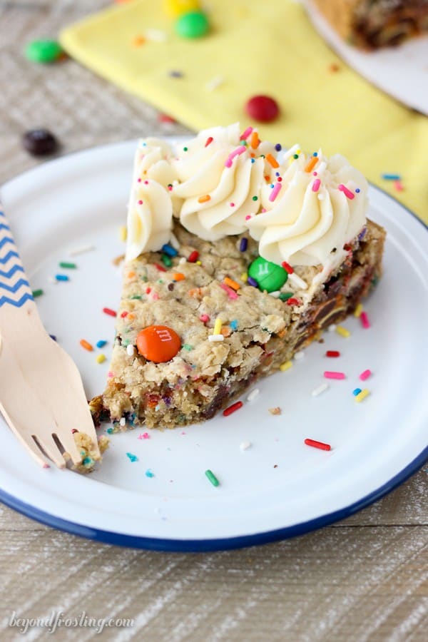 This Cake Batter Monster Cookie Cake is an cake batter oatmeal cookie with MnMs and sprinkles. It’s topped with a little vanilla buttercream.