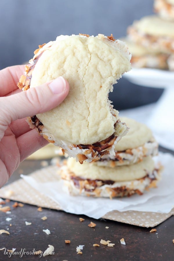 Don't be shy, take a giant bite out of these Samoa Cookie Sandwiches. They are totally irresistible!