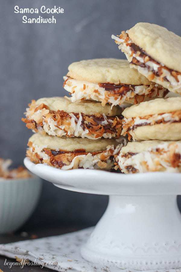 These Samoa Cookie Sandwiches are completely irresistible. The caramel buttercream is sandwiched between two chewy sugar cookies coated with chocolate sauce and rolled in toasted coconut.