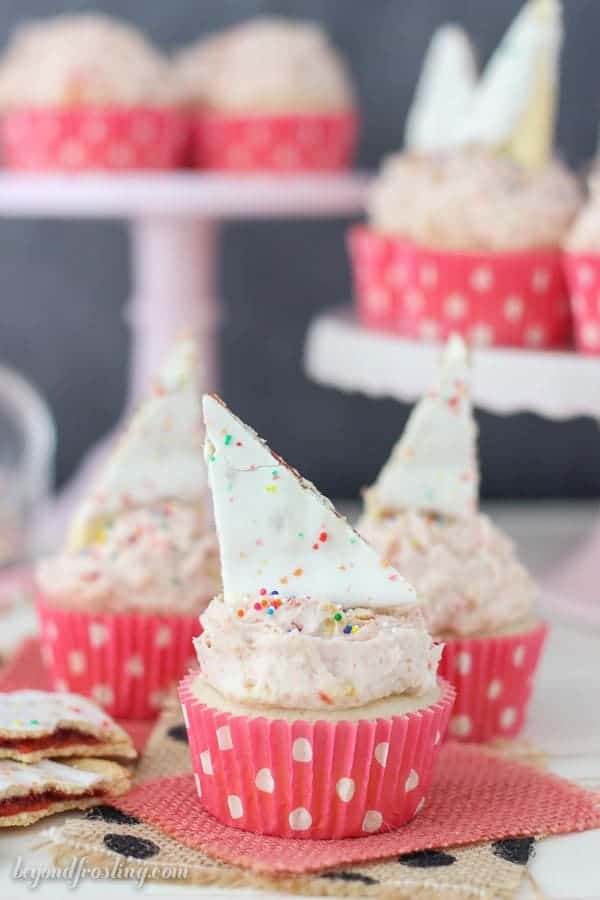 These Strawberry Pop Tart cupcakes are filled with a strawberry jam. The recipe for the Pop Tart Frosting is the best part!