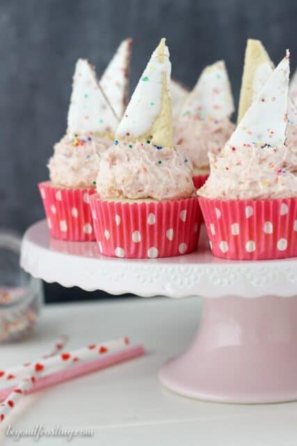 You won't be able to resist these Pop Tart Cupcakes! The vanilla cupcake is filled with strawberry jam and topped with a Strawberry Pop Tart frosting.