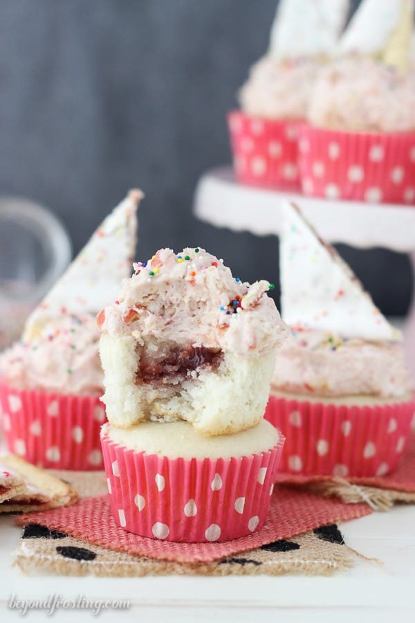 These Strawberry Pop Tart cupcakes are filled with a strawberry jam. The recipe for the Pop Tart Frosting is the best part!