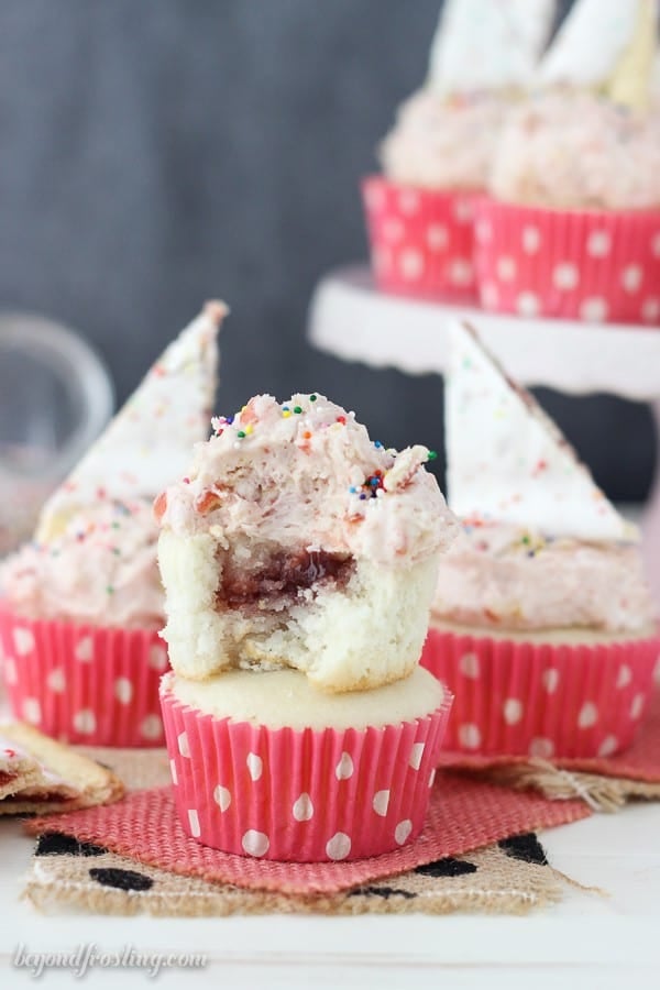 These Strawberry Pop Tart cupcakes are filled with a strawberry jam. The recipe for the Pop Tart Frosting is the best part!