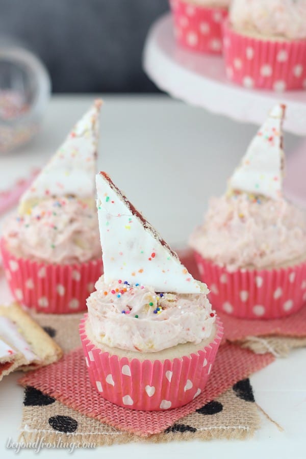 You won't be able to resist these Pop Tart Cupcakes! The vanilla cupcake is filled with strawberry jam and topped with a Strawberry Pop Tart frosting.