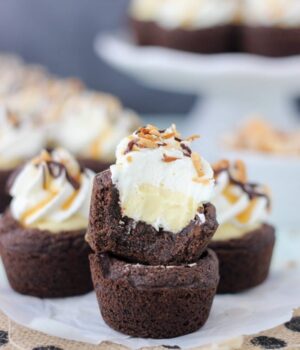 These Samoa Cream Pie Cookie Cups are a soft chocolate pudding cookie, vanilla-caramel mousse filling and topped with homemade whipped cream, toasted coconut, caramel and hot fudge.