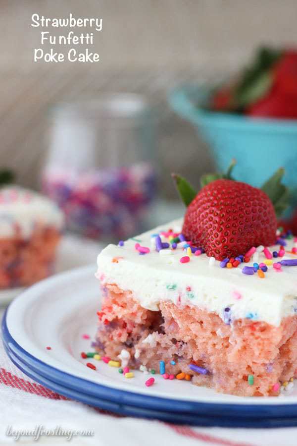 A slice of strawberry poke cake on a plate