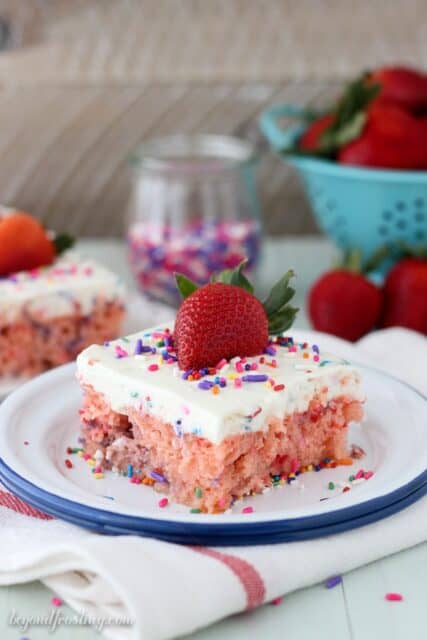 This strawberry cake is drenched in sweetened condensed milk. The funfetti whipped cream is the best topping for this cake! This is about to become your new favorite cake!