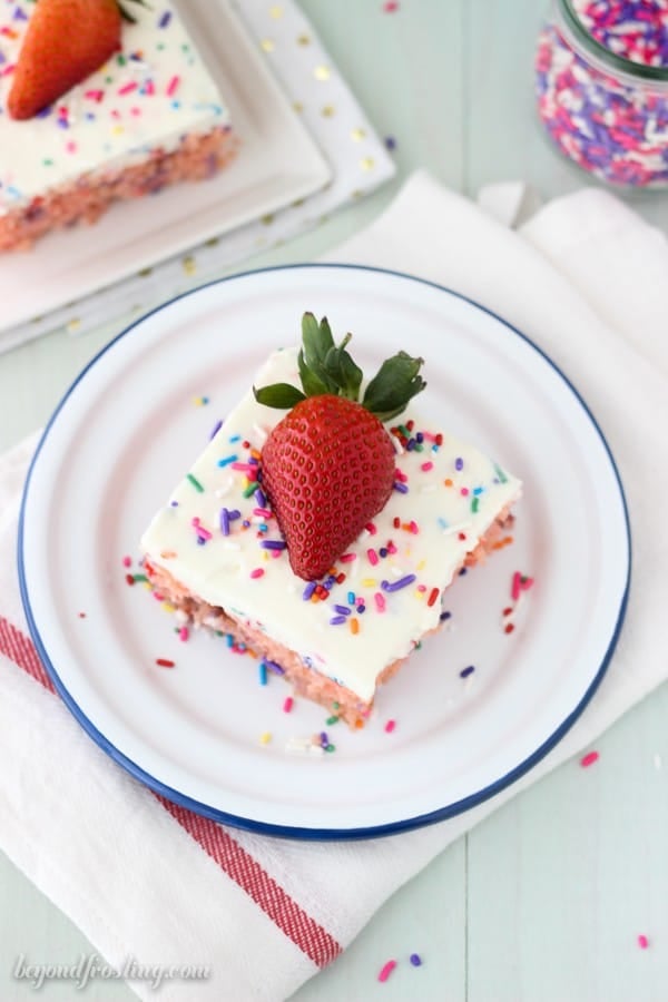 Top view of a strawberry poke cake slice with whipped cream frosting
