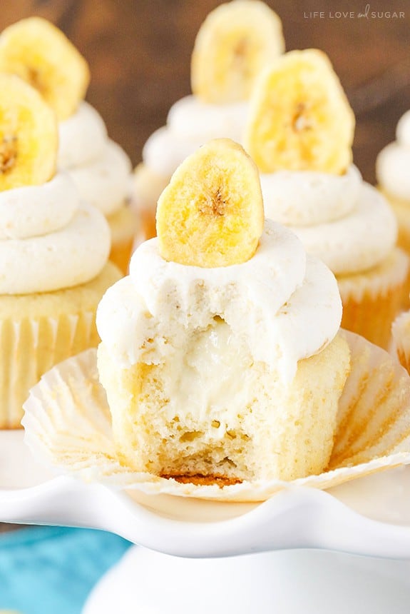 A Banana Cream Pie Cupcake with a Bite Taken Out to Reveal its Gooey Center