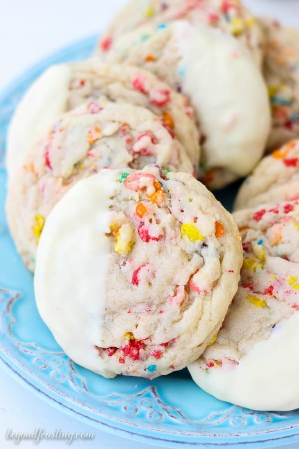 Everyone needs some Fruity Pebble Cookies in their life. These soft and chewy Fruity Pebbles Cookies. The buttery sugar cookies are loaded with Fruity Pebbles and dipped in white chocolate.