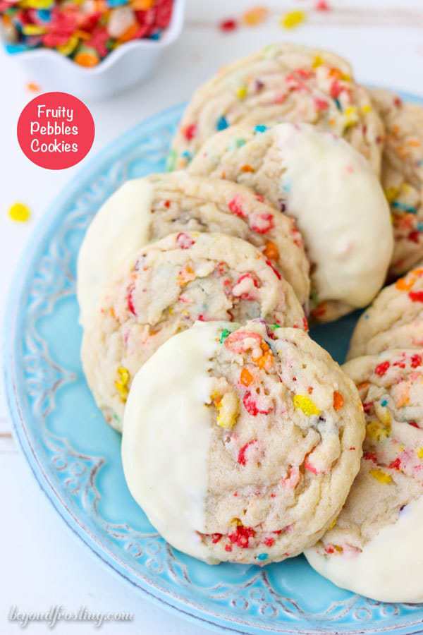 Everyone needs some Fruity Pebble Cookies in their life. These soft and chewy Fruity Pebbles Cookies. The buttery sugar cookies are loaded with Fruity Pebbles and dipped in white chocolate.