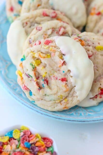 These super fun Fruity Pebbles Cookies are a soft-baked sugar cookie stuffed with fruity pebbles and dipped in white chocolate.