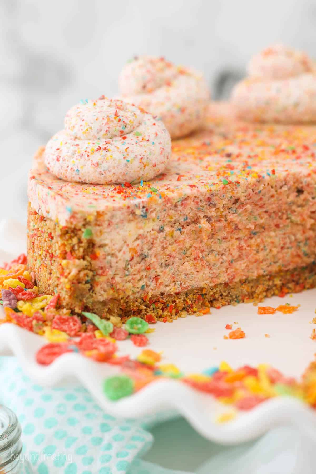 No bake fruity pebbles cheesecake with a slice cut out