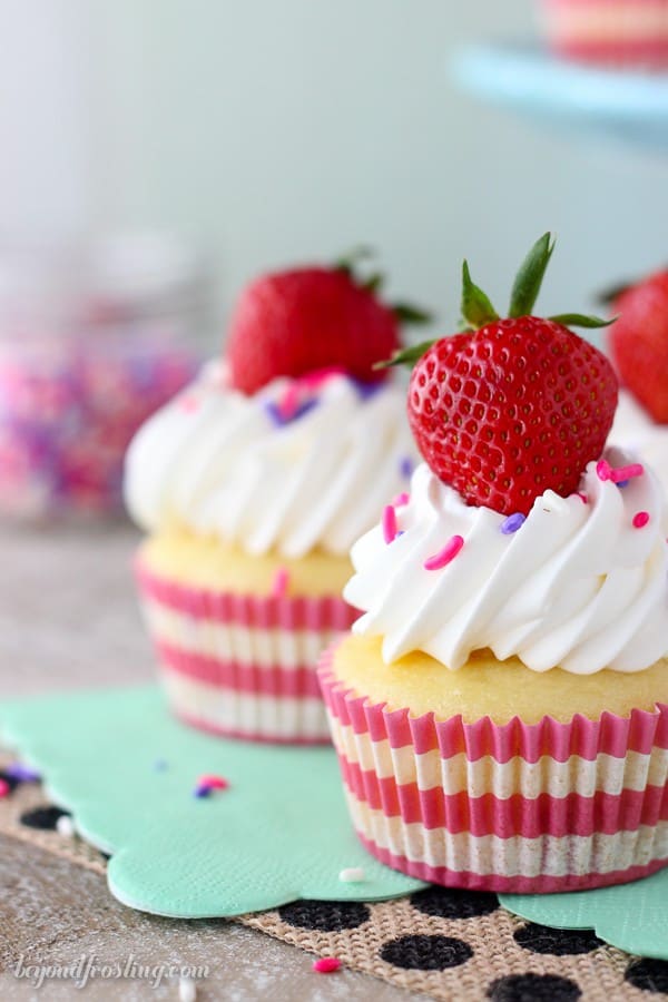 Take a big bite out of these Easy Strawberry and Cream Cupcakes! The strawberry cupcake are filled with a lightened up mousse and topped with whipped cream.